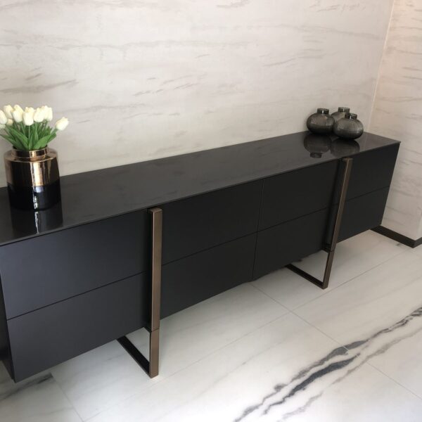 Bespoke matt black sideboard with bronze legs in dining room