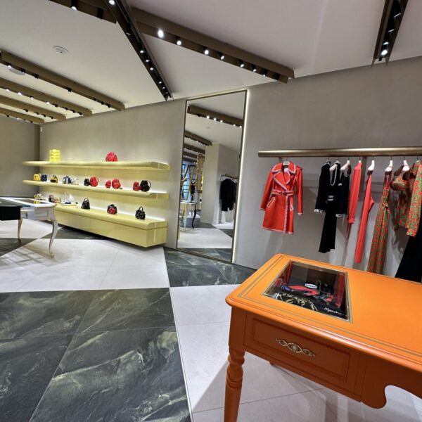 Womenswear floor with chequerboard marble floor and bronze ceiling fins, Moschino London