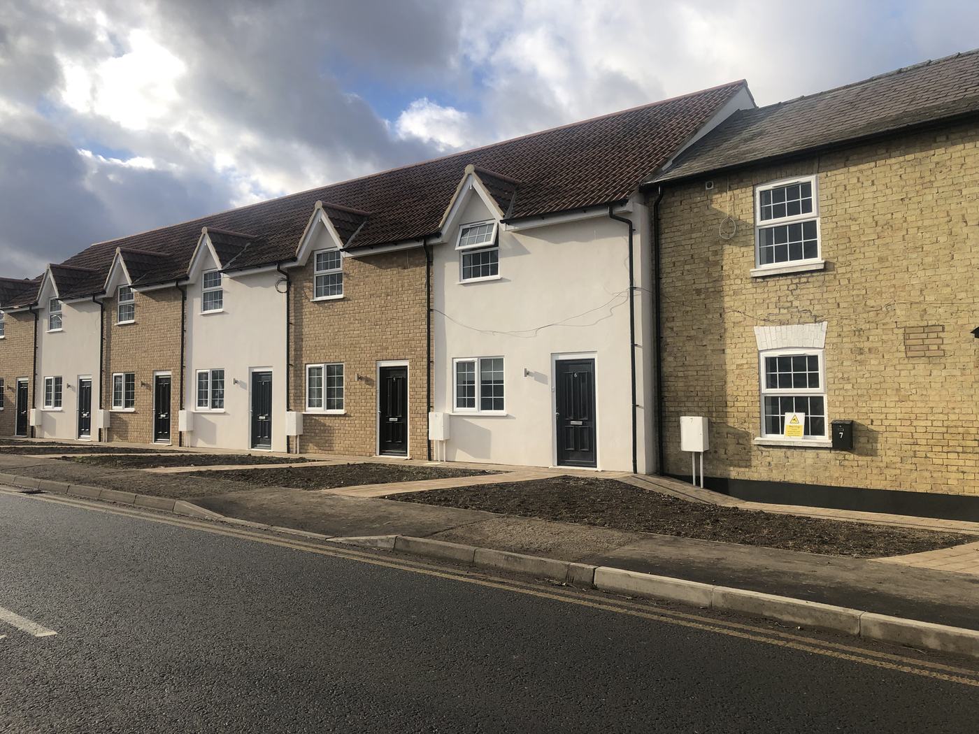 new-build-terraced-houses-street-02: Street view of new-build terraced houses in Purley, a project by Raffaello Fair
